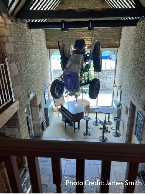 A Farm Tractor Was Suspended from A Beam